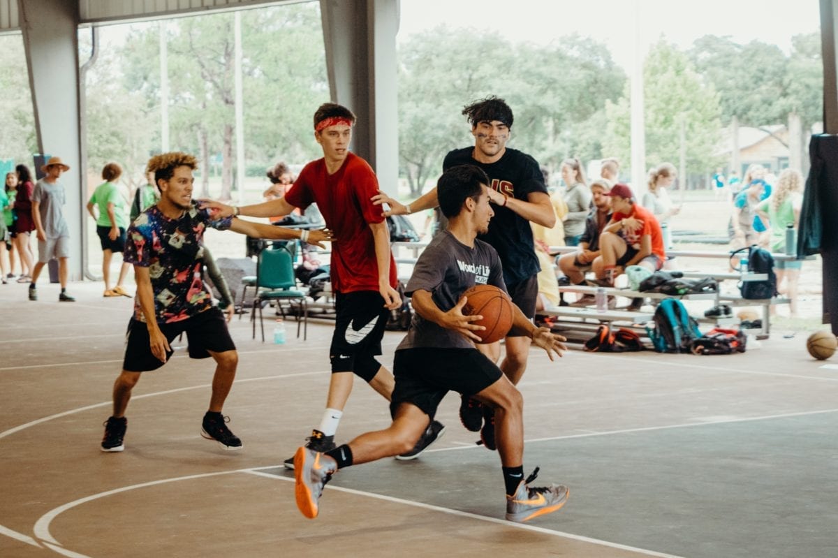 Guys playing basketball.