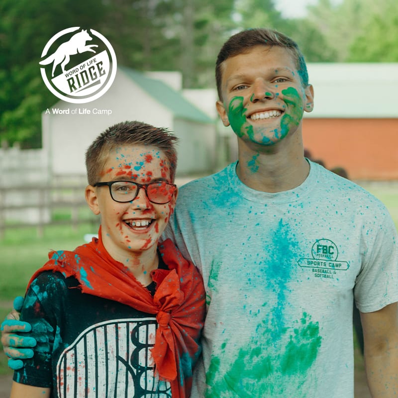 Word of life Ridge - two kids smiling covered in paint.