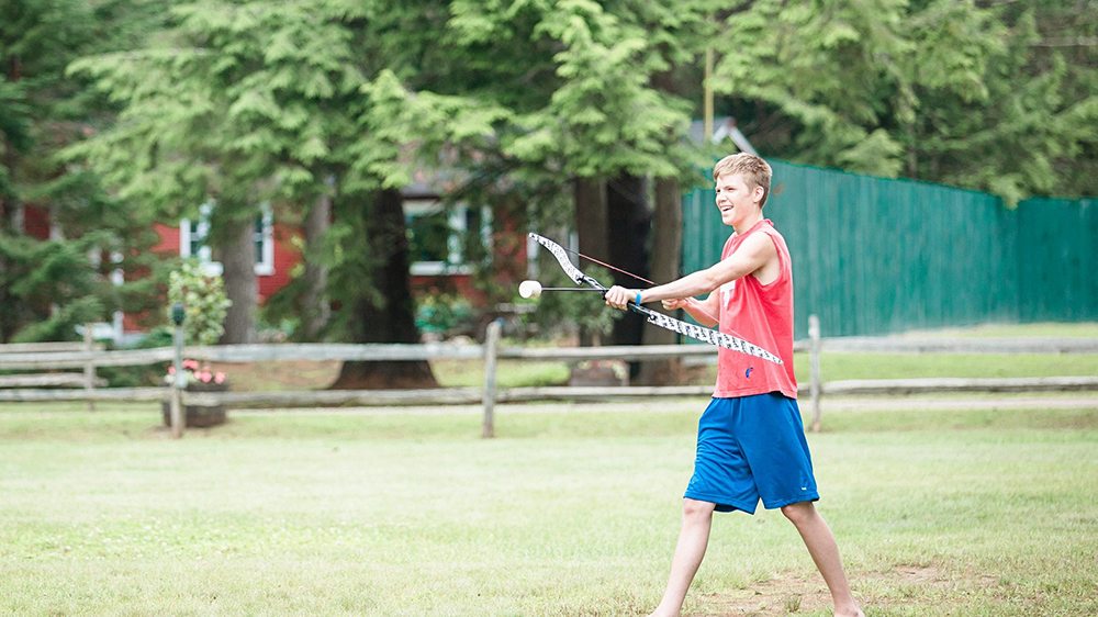 Guy notching an arrow for archery tag.