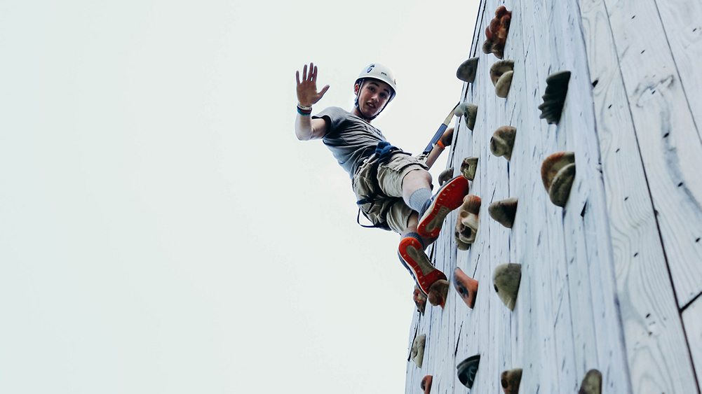 Person climbing a climbing tower.