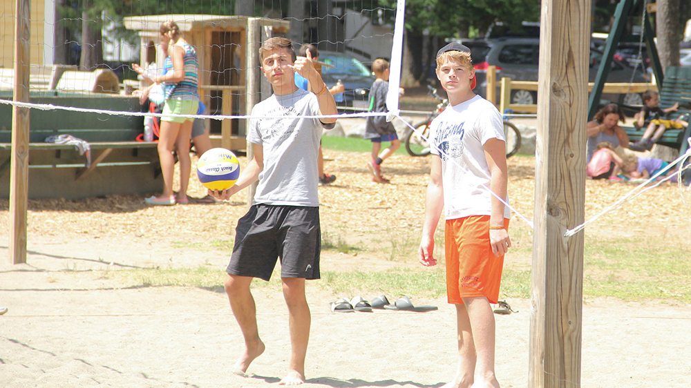 Two guys playing volleyball