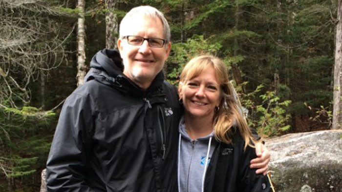 Dwight Peterson and wife in the woods.